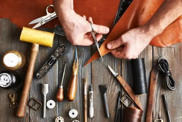 Premium Photo  Leather craft or leather working leather working tools and  cut out pieces of leather on work desk